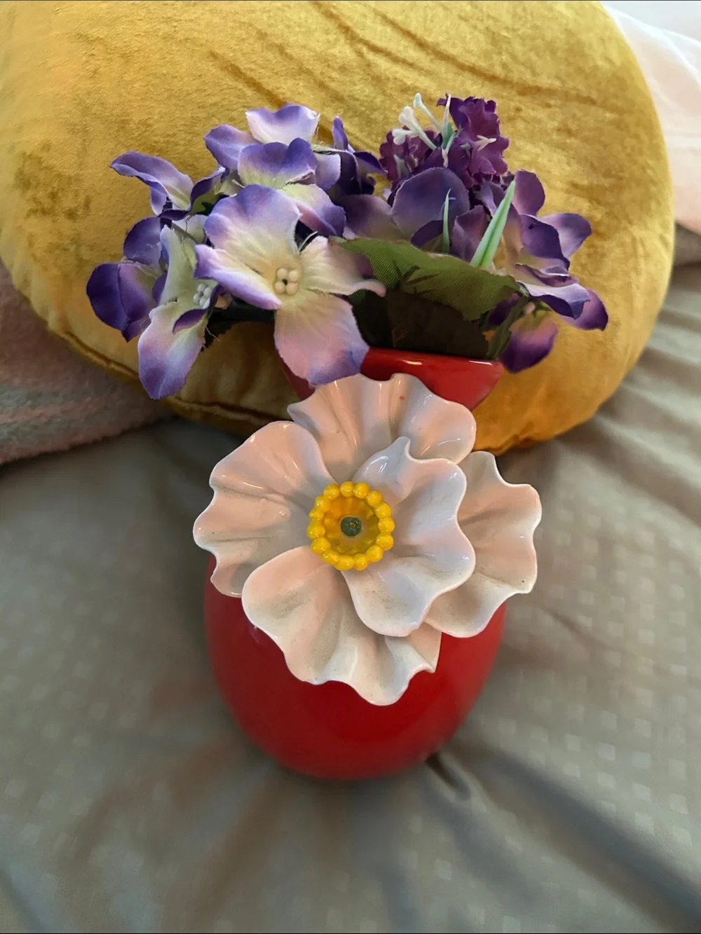 Anthropologie red ceramic vase with white floral accent and purple blooms
